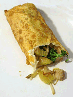 An egg roll with its filling visible