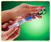 A syringe being filled from an insulin vial