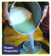 Liquid whey being poured into a bowl